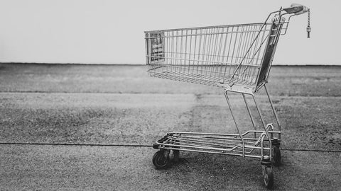 A grey shopping cart standing alone
