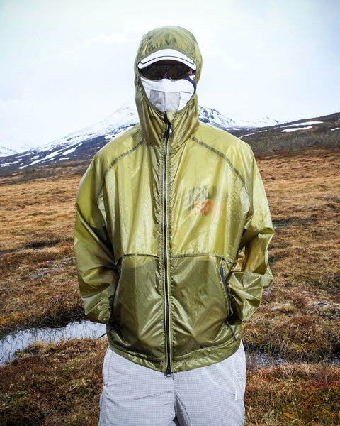 Harlaut Apparel outdoor campaign photography, model wearing an olive technical jacket