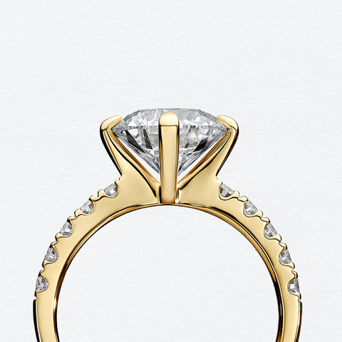 Sif Jakobs gold solitaire engagement ring with a pave set band